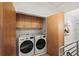 Convenient laundry room boasts modern washer and dryer with custom wood cabinetry at 1344 Fernwood Ne Cir, Brookhaven, GA 30319
