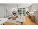 Living room features fireplace, natural light, brick accent wall, wood flooring, and modern decor at 1344 Fernwood Ne Cir, Brookhaven, GA 30319