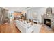 Open-concept living room with a fireplace, wood floors, and staircase to the upper level at 1344 Fernwood Ne Cir, Brookhaven, GA 30319