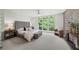 Bright main bedroom boasts large windows with scenic views, complemented by brick accent wall and neutral decor at 1344 Fernwood Ne Cir, Brookhaven, GA 30319