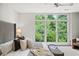 Bright main bedroom offers a picturesque view through a large window, enhancing the room's serene ambiance at 1344 Fernwood Ne Cir, Brookhaven, GA 30319