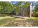 Spacious and shady backyard, featuring a large wooden deck perfect for outdoor gatherings and leisure at 224 Farm Manor Ct, Lawrenceville, GA 30045