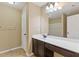Bathroom featuring a modern vanity with a dark wood cabinet, large mirror and a white countertop with a sink at 224 Farm Manor Ct, Lawrenceville, GA 30045