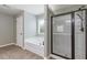 Bathroom with soaking tub and glass-enclosed shower at 224 Farm Manor Ct, Lawrenceville, GA 30045