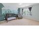 Bright bedroom features a crib, gray chair and a mural of trees, and large windows flood the space with natural light at 224 Farm Manor Ct, Lawrenceville, GA 30045
