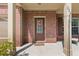 Close-up of the brick front porch with a cozy seating area and inviting front door with seasonal wreath at 224 Farm Manor Ct, Lawrenceville, GA 30045