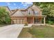 Charming two-story home boasts a well-manicured lawn, brick accents, and an inviting front porch at 224 Farm Manor Ct, Lawrenceville, GA 30045