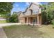 Inviting two-story home with a well-kept lawn, brick accents, and a cozy covered front porch at 224 Farm Manor Ct, Lawrenceville, GA 30045