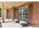 Inviting front porch with comfortable seating, brick accents, and a view of the front door at 224 Farm Manor Ct, Lawrenceville, GA 30045