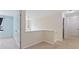 Neutral hallway connects rooms; chandelier hangs in open area, and natural light illuminates the carpeted floor at 224 Farm Manor Ct, Lawrenceville, GA 30045