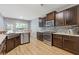 Kitchen with stainless appliances, sink, and wood-look floors at 224 Farm Manor Ct, Lawrenceville, GA 30045
