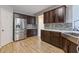 Kitchen with stainless refrigerator and dark wood cabinets at 224 Farm Manor Ct, Lawrenceville, GA 30045