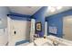 Bright blue bathroom with a shower-tub combo and a vanity with a large mirror at 255 Webster Lake Dr, Temple, GA 30179