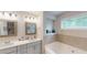 Bright bathroom with a soaking tub, double sinks, and recessed lighting at 255 Webster Lake Dr, Temple, GA 30179