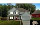 Charming two-story home with a well-manicured lawn, two-car garage, and inviting red front door at 255 Webster Lake Dr, Temple, GA 30179