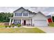 Charming two-story home with a well-manicured lawn, covered front porch and attached garage at 255 Webster Lake Dr, Temple, GA 30179
