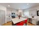 The modern kitchen features an island with seating, stainless steel appliances, and ample counter space at 255 Webster Lake Dr, Temple, GA 30179