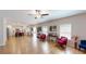 Open-concept living room with hardwood floors seamlessly connects to the modern kitchen at 255 Webster Lake Dr, Temple, GA 30179
