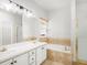 Bathroom boasts double sinks, ample counter space, a soaking tub, and a shower with glass door at 3042 Oak Vista Way, Lawrenceville, GA 30044
