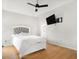 Spacious bedroom with hardwood floors, modern ceiling fan, and an ensuite bathroom at 3042 Oak Vista Way, Lawrenceville, GA 30044