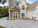 Close up on the front of the two-story home with stone accents and well-maintained landscaping at 3042 Oak Vista Way, Lawrenceville, GA 30044