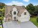 Two-story home with stone accents, attached two-car garage, and well-maintained landscaping at 3042 Oak Vista Way, Lawrenceville, GA 30044