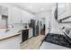 Updated kitchen boasting white cabinets, stainless steel appliances, and a tile backsplash at 3042 Oak Vista Way, Lawrenceville, GA 30044