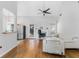 Bright living room featuring hardwood floors, fireplace with white mantel and stainless steel appliances at 3042 Oak Vista Way, Lawrenceville, GA 30044