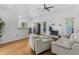 Bright living room featuring hardwood floors, fireplace with white mantel and stainless steel appliances at 3042 Oak Vista Way, Lawrenceville, GA 30044