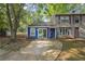 Charming townhome with a blue and tan exterior, complemented by a concrete driveway and mature trees at 3799 Henry Ct, Acworth, GA 30101