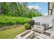 Relaxing patio area with fire pit, comfortable seating, and lush green surroundings at 20056 Windalier Way, Roswell, GA 30076