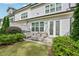 Outdoor patio features a fire pit and comfortable seating overlooking landscaped yard at 20056 Windalier Way, Roswell, GA 30076