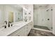 Bright bathroom offers double vanity, walk-in shower with a glass door, and tile flooring at 20056 Windalier Way, Roswell, GA 30076