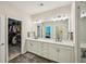 Bright bathroom featuring a double vanity, modern fixtures, and a walk-in closet at 20056 Windalier Way, Roswell, GA 30076