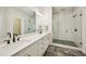Modern bathroom showcasing a double vanity, sleek hardware, and a glass enclosed shower at 20056 Windalier Way, Roswell, GA 30076