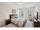 Well-lit bedroom with neutral tones, comfortable bed, and view to outside at 20056 Windalier Way, Roswell, GA 30076
