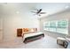 Bright bedroom with neutral tones, ceiling fan, carpet, and large window at 20056 Windalier Way, Roswell, GA 30076
