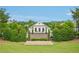 An outdoor view of the clubhouse surrounded by large trees and other manicured greenery at 20056 Windalier Way, Roswell, GA 30076