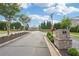 Serene community entrance with brick pillars, manicured lawns, and tree-lined streets at 20056 Windalier Way, Roswell, GA 30076