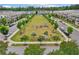 Community green with Gathering gatherings in a neighborhood lined with beautiful townhomes and trees at 20056 Windalier Way, Roswell, GA 30076