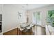 Bright dining area with modern table, stylish chandelier, and patio access at 20056 Windalier Way, Roswell, GA 30076