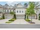 Beautiful townhome featuring a brick facade and a two-car garage with manicured landscaping at 20056 Windalier Way, Roswell, GA 30076