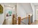 Upstairs hallway with hardwood floors, wood railing, and views into bedrooms at 20056 Windalier Way, Roswell, GA 30076