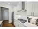 Sleek kitchen with stainless steel range hood, gas cooktop, and ample counter space for meal preparation at 20056 Windalier Way, Roswell, GA 30076