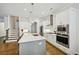 Modern kitchen with a large island, stainless steel appliances, and easy access to the staircase at 20056 Windalier Way, Roswell, GA 30076