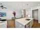 Contemporary kitchen featuring an island with a sink, stainless steel appliances, and seamless flow to the living space at 20056 Windalier Way, Roswell, GA 30076