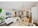 Open-concept living and dining area with hardwood floors, modern lighting, and stylish decor at 20056 Windalier Way, Roswell, GA 30076