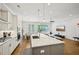 Stylish living area features a modern kitchen with a breakfast bar, dining space, and comfortable seating at 20056 Windalier Way, Roswell, GA 30076