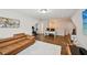 Open-concept living room with hardwood floors, modern furniture, and lots of natural light at 20056 Windalier Way, Roswell, GA 30076