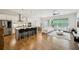 Open-concept living space features a modern kitchen, dining area, and cozy living room with large windows at 20056 Windalier Way, Roswell, GA 30076